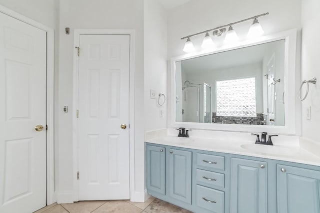 bathroom with tile patterned flooring, vanity, and a shower with door