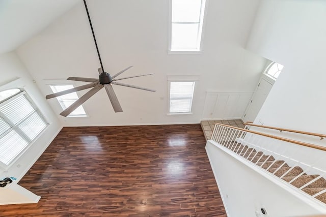 unfurnished living room featuring dark hardwood / wood-style floors and high vaulted ceiling