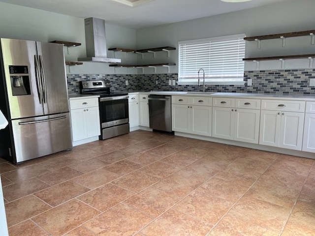 kitchen featuring appliances with stainless steel finishes, sink, light tile patterned floors, decorative backsplash, and wall chimney exhaust hood