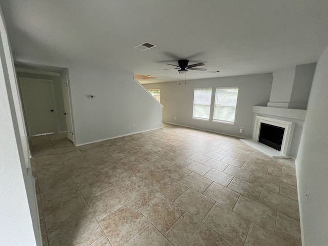 unfurnished living room with light tile patterned flooring and ceiling fan