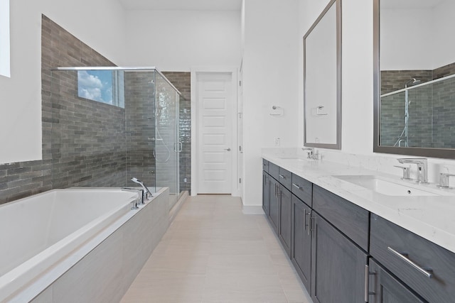 bathroom with shower with separate bathtub, double vanity, and tile patterned flooring