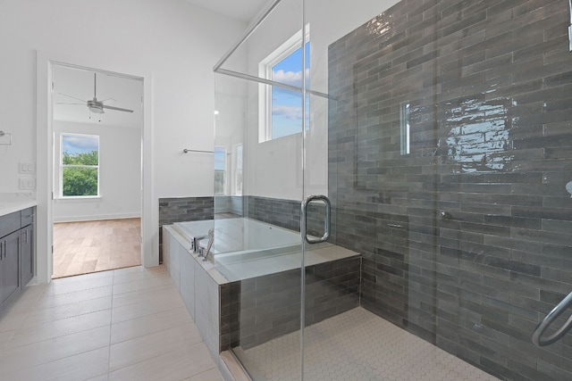 bathroom with vanity, separate shower and tub, wood-type flooring, and ceiling fan