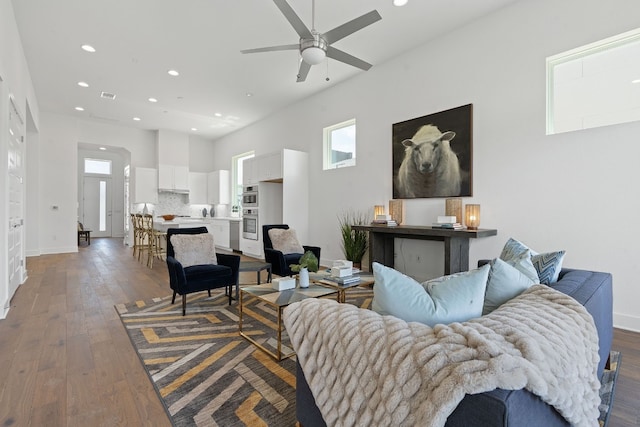 living room with ceiling fan and hardwood / wood-style floors