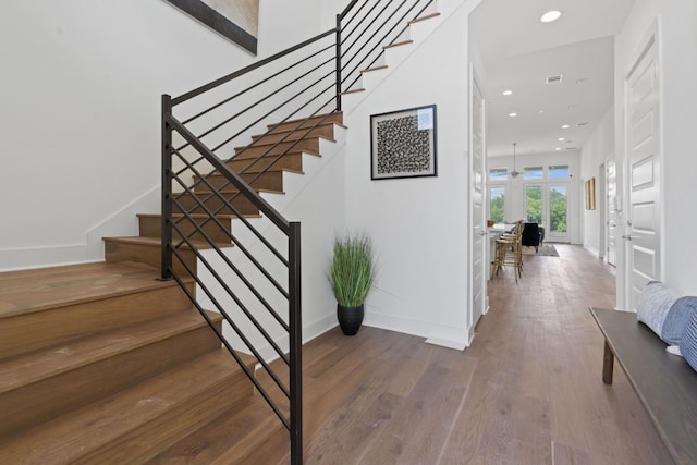 staircase with hardwood / wood-style flooring