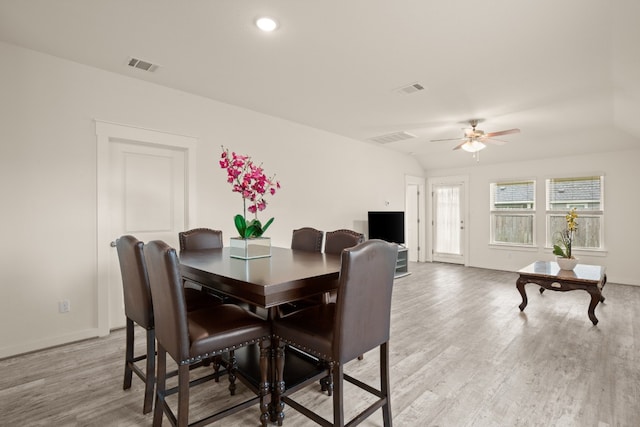 dining room with light hardwood / wood-style floors, lofted ceiling, and ceiling fan