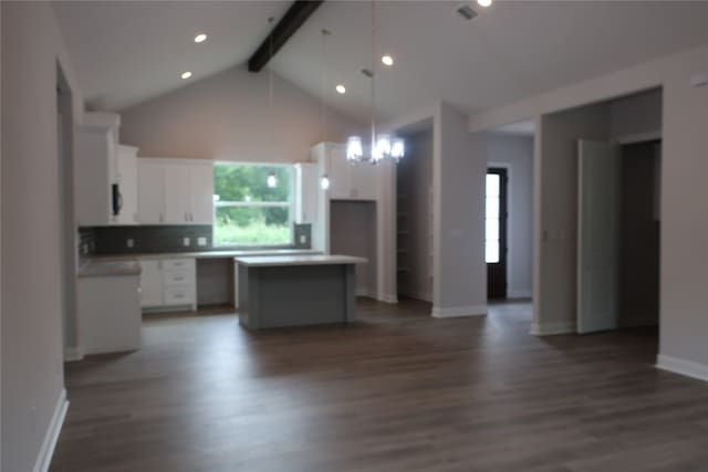 kitchen featuring a kitchen island, dark hardwood / wood-style floors, and white cabinets