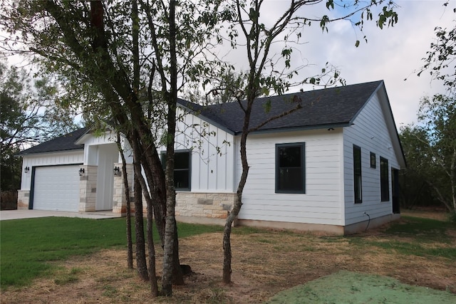 view of front of home with a garage and a front lawn