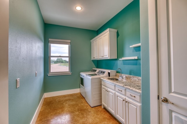 laundry area with sink, cabinets, and washing machine and dryer