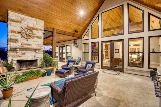 patio terrace at dusk with an outdoor living space with a fireplace