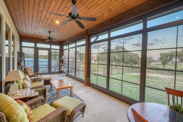 sunroom with ceiling fan and wood ceiling