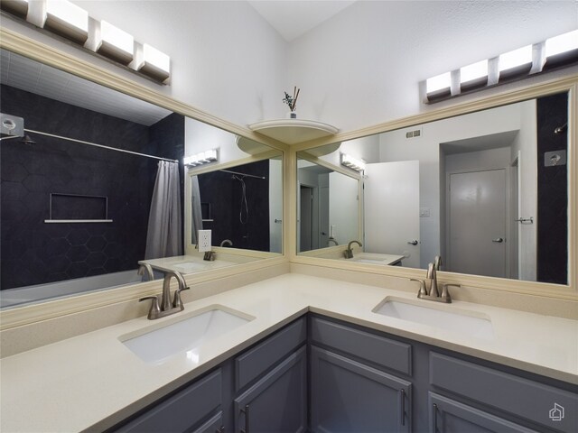 bathroom with double vanity and toilet