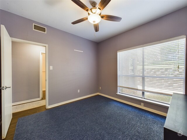 empty room with ceiling fan and wood-type flooring