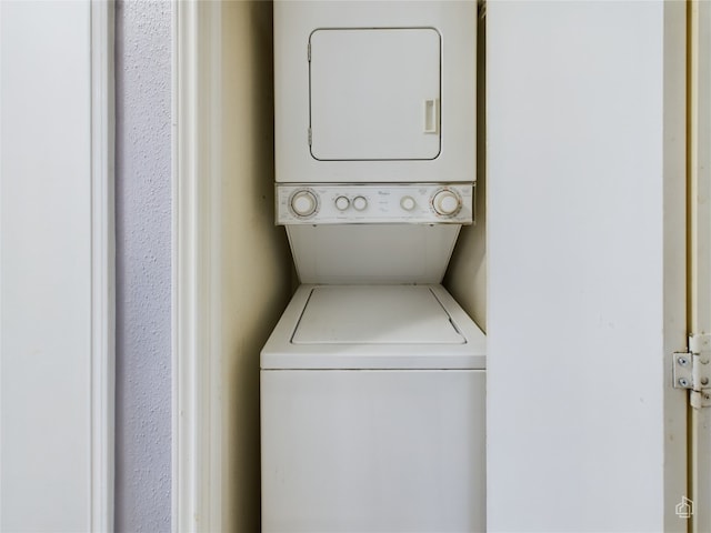 laundry area with stacked washer and clothes dryer