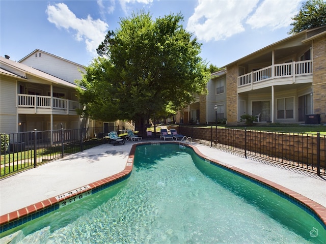 view of pool with a patio and central AC