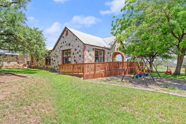 view of yard with a wooden deck and a playground