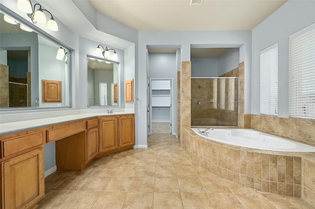 bathroom featuring tile patterned floors, plus walk in shower, and vanity