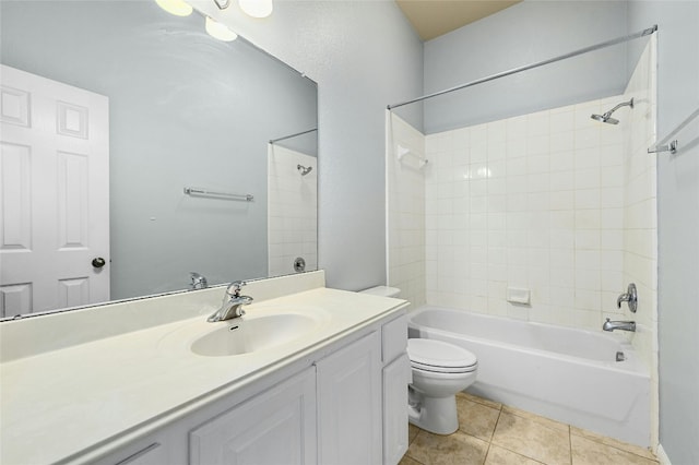 full bathroom with tiled shower / bath combo, vanity, tile patterned floors, and toilet