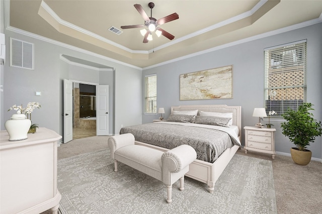 bedroom featuring ornamental molding, carpet flooring, ceiling fan, and a tray ceiling