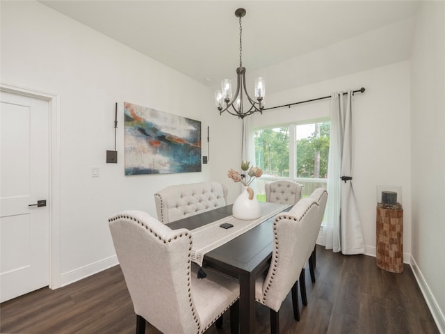 dining room featuring lofted ceiling, dark hardwood / wood-style floors, and a chandelier