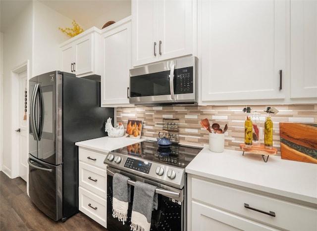 kitchen featuring stainless steel appliances, dark hardwood / wood-style flooring, decorative backsplash, and white cabinets