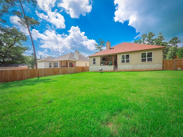 back of property featuring a lawn