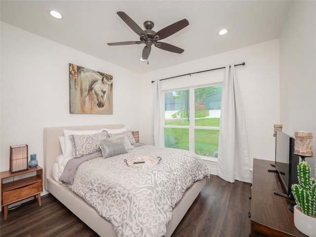 bedroom with ceiling fan and dark hardwood / wood-style flooring