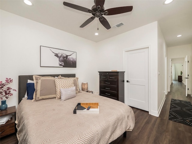 bedroom with dark hardwood / wood-style floors and ceiling fan