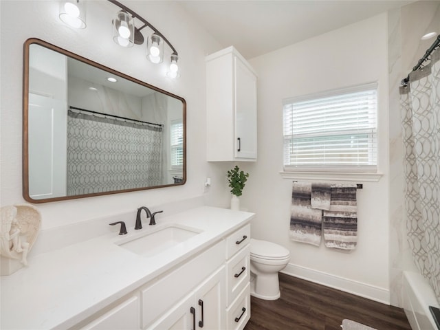 full bathroom with wood-type flooring, vanity, shower / bath combo with shower curtain, and toilet