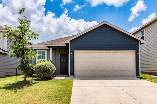 view of front of home with a garage and a front yard