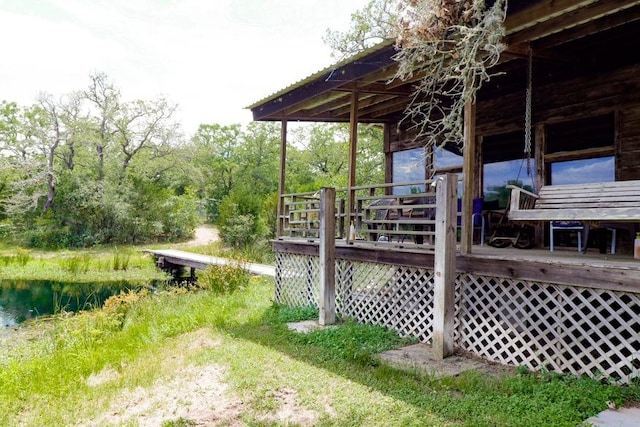 view of yard with a deck with water view