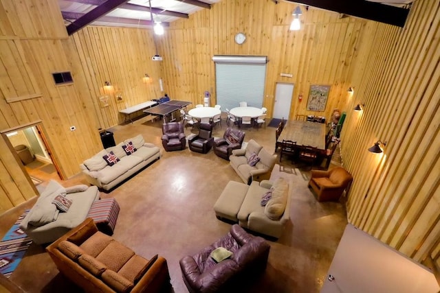 interior space featuring beam ceiling and wood walls