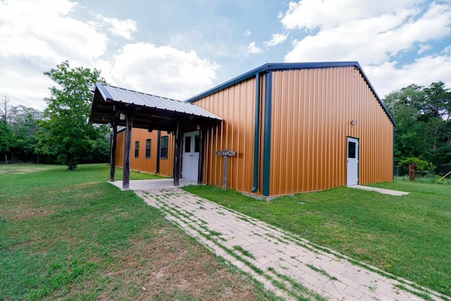 view of outbuilding featuring a lawn