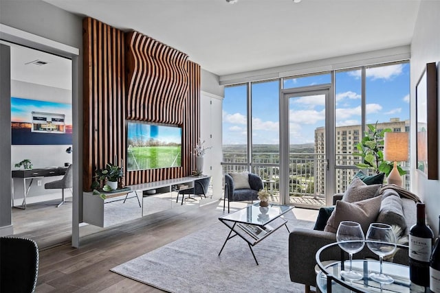 living room with hardwood / wood-style flooring and a healthy amount of sunlight