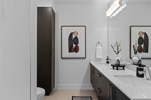 bathroom featuring tile patterned flooring, vanity, and toilet