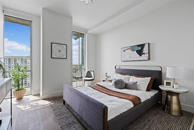 bedroom featuring hardwood / wood-style flooring and access to outside