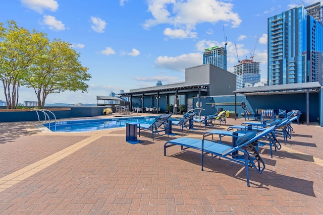 community pool featuring a city view and a patio