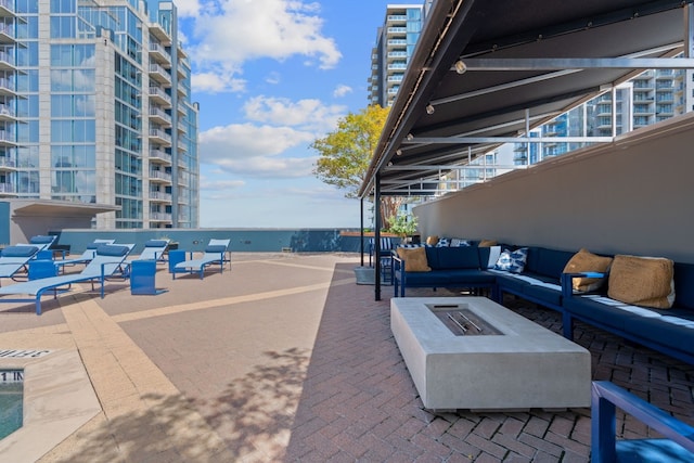 view of patio / terrace featuring an outdoor living space with a fire pit