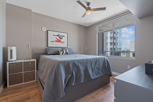 bedroom with ceiling fan and hardwood / wood-style flooring