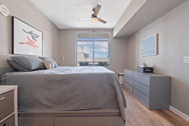 bedroom with ceiling fan and light hardwood / wood-style floors