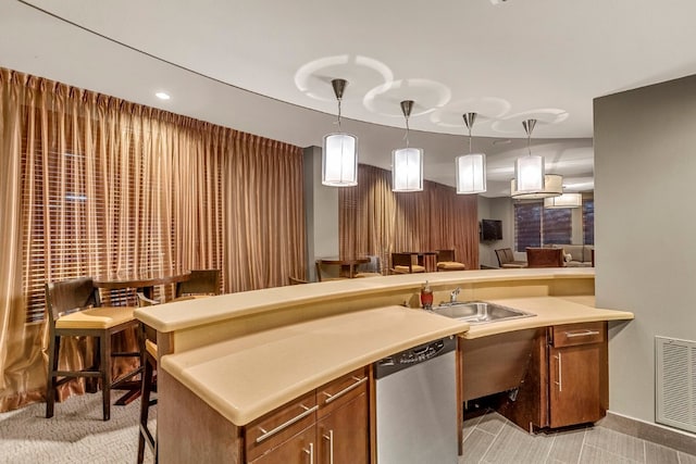 kitchen with stainless steel dishwasher, sink, and pendant lighting