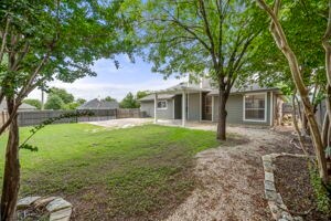 rear view of property featuring a lawn