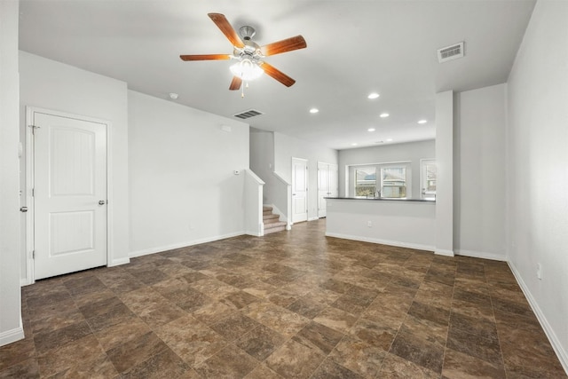 unfurnished living room with recessed lighting, visible vents, baseboards, and stairs