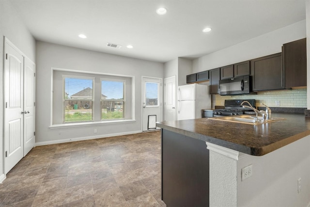 kitchen with dark brown cabinetry, sink, backsplash, kitchen peninsula, and black appliances