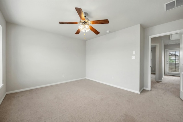 carpeted spare room featuring ceiling fan