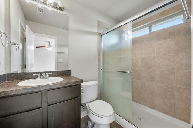 full bathroom featuring visible vents, a shower stall, ceiling fan, toilet, and vanity