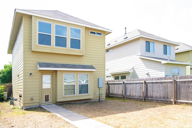 rear view of property with fence