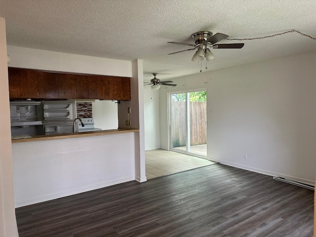 kitchen featuring ceiling fan, dark hardwood / wood-style floors, a textured ceiling, and white fridge