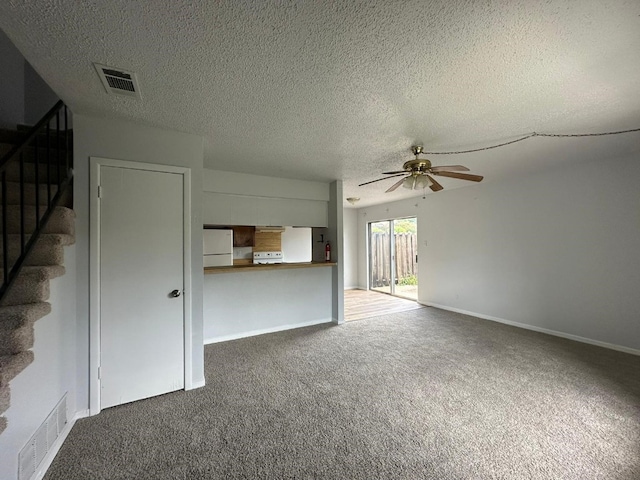 unfurnished living room featuring dark carpet, a textured ceiling, and ceiling fan