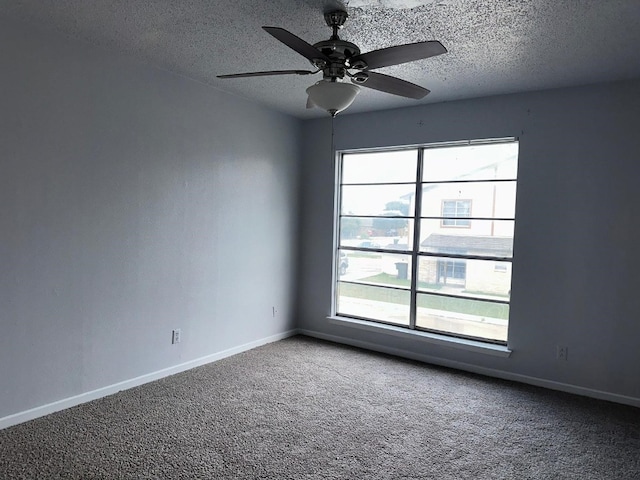 carpeted spare room with ceiling fan and a textured ceiling