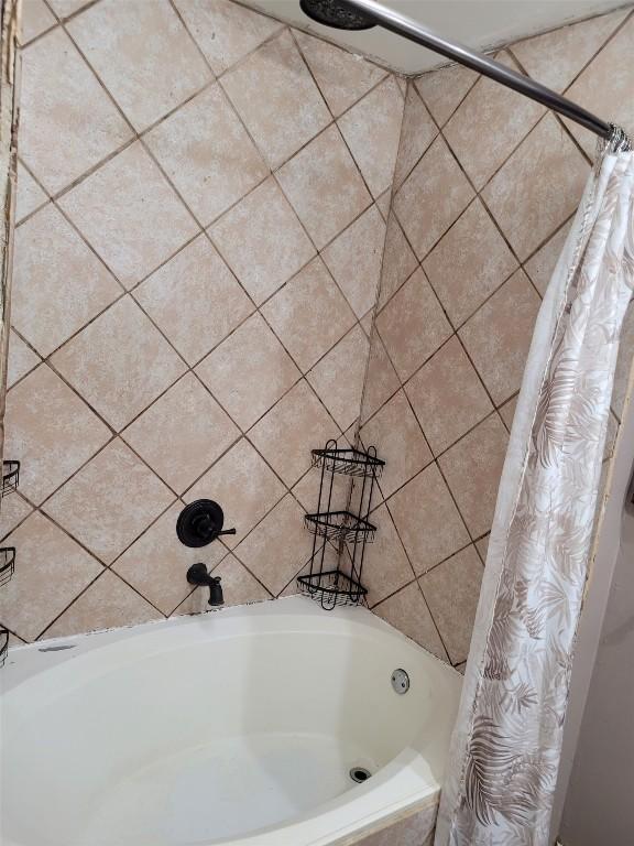 bathroom with shower / bath combo with shower curtain